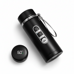 Black thermos bottle with digital temperature display on a gray surface